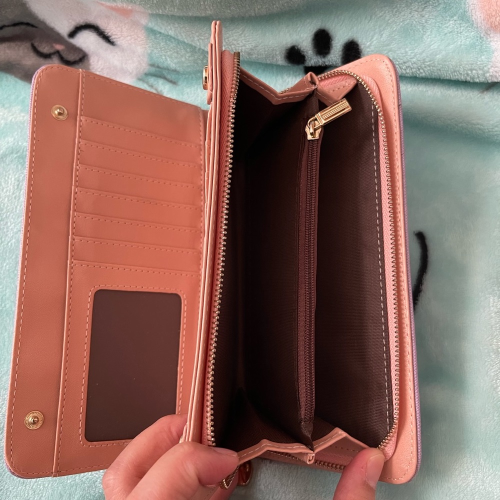 Cute long wallet with a lot of slots to put ur cash and recipts in..